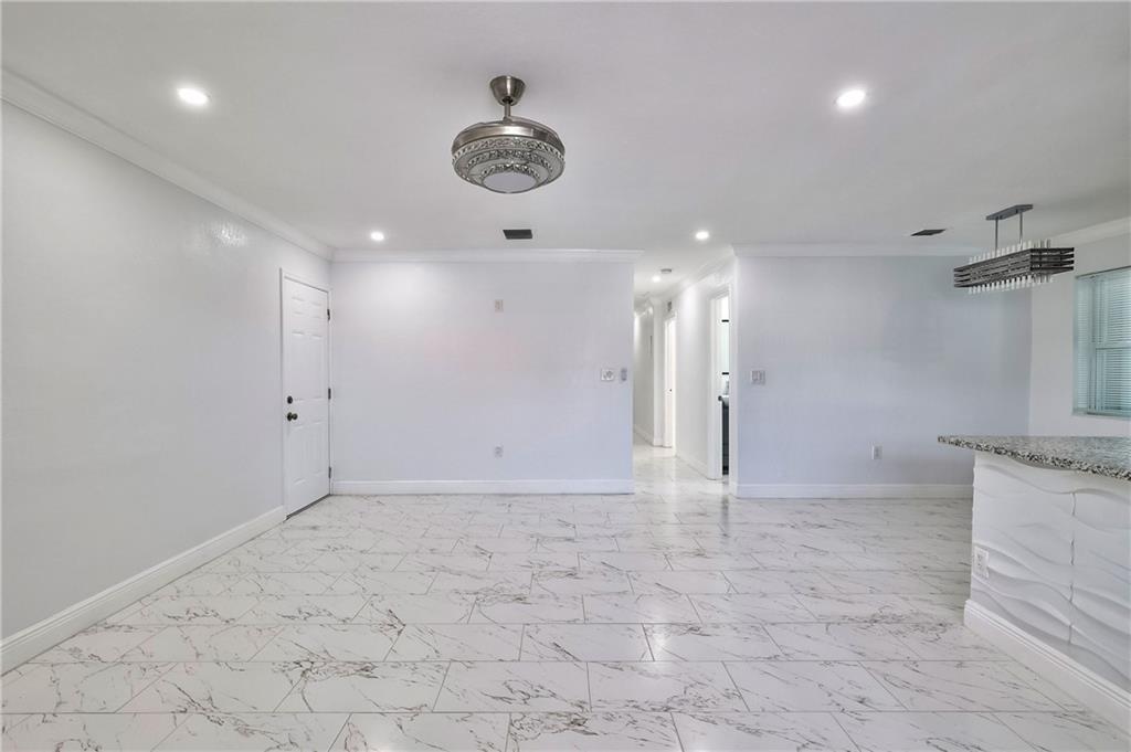 1389 West 33rd Street Riviera Beach, FL 33404 - Photo 9 of 20 a view of a kitchen with a sink and a refrigerator