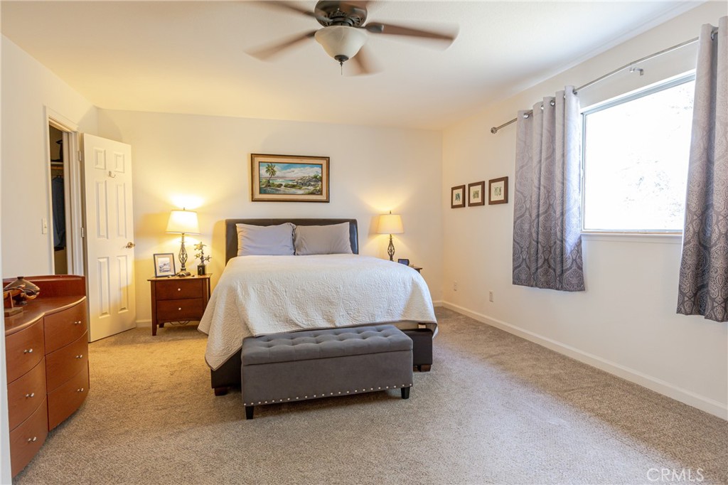 30142 Revis Road Coarsegold, CA 93614 - Photo 20 of 43 a spacious bedroom with a bed and a window
