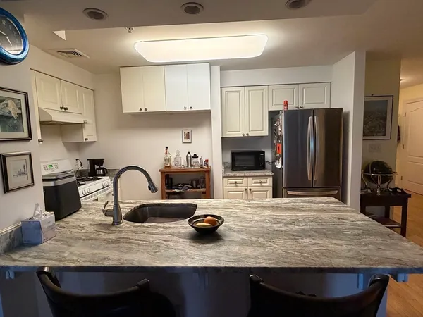 a kitchen with sink a stove and refrigerator