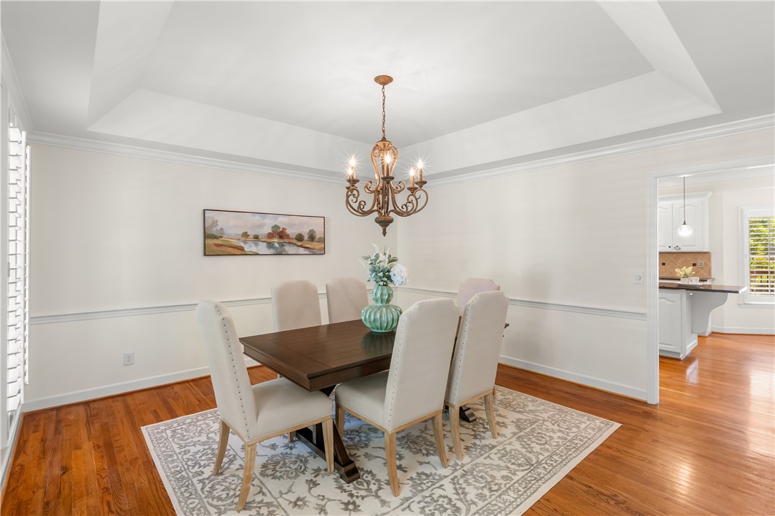 312 English Oak Road Simpsonville, SC 29681 - Photo 13 of 48 This dining area features hardwood floors and elegant crown molding, ideal for memorable gatherings.