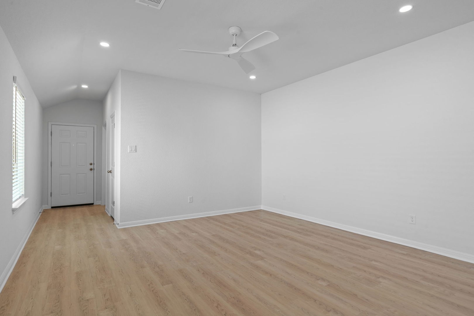 141 Hatari Trail Jarrell, TX 76537 - Photo 7 of 36 an empty room with wooden floor and a ceiling fan