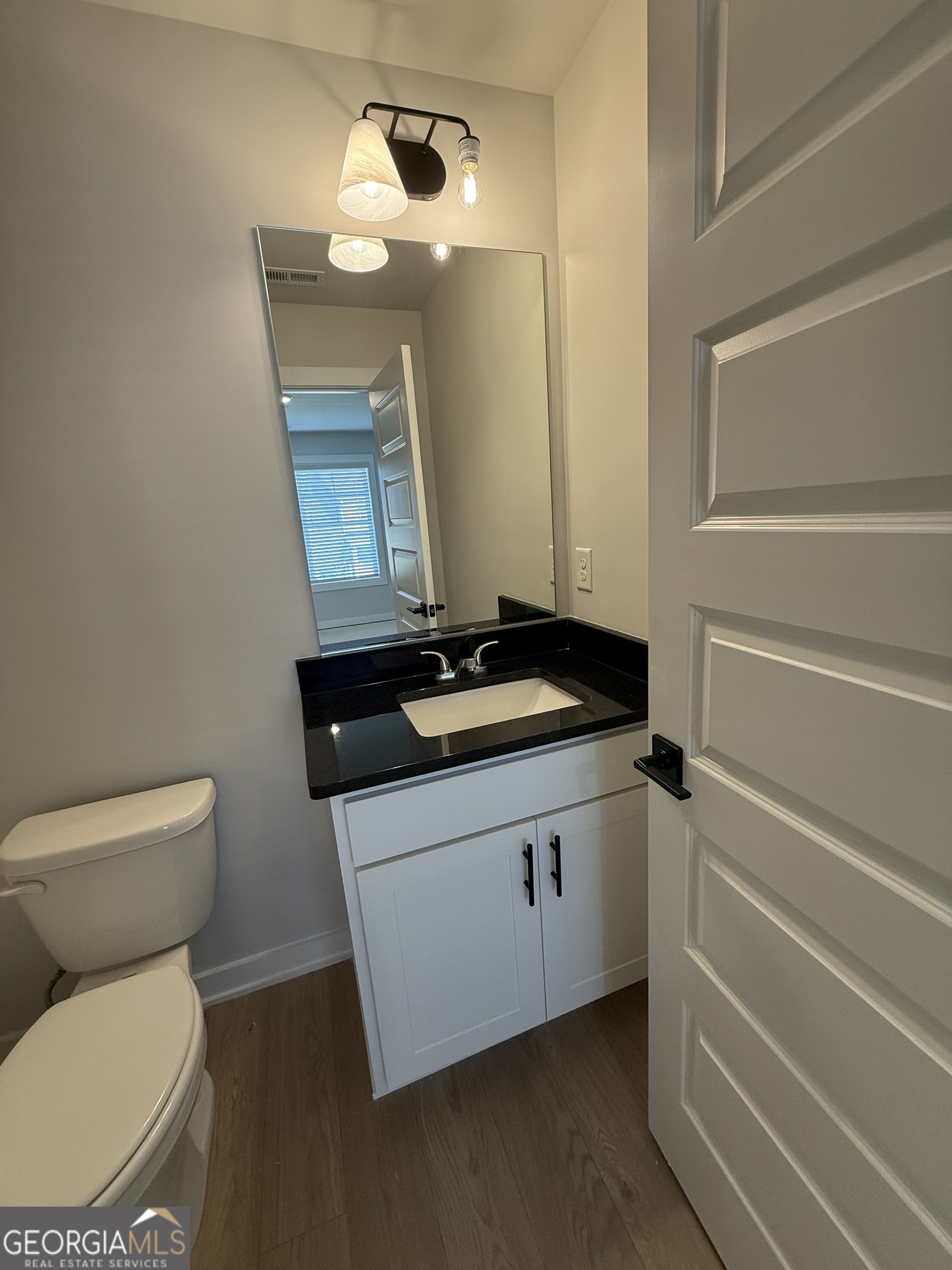 210 Villa Rica Springs Villa Rica, GA 30180 - Photo 12 of 24 a bathroom with a toilet a sink and mirror