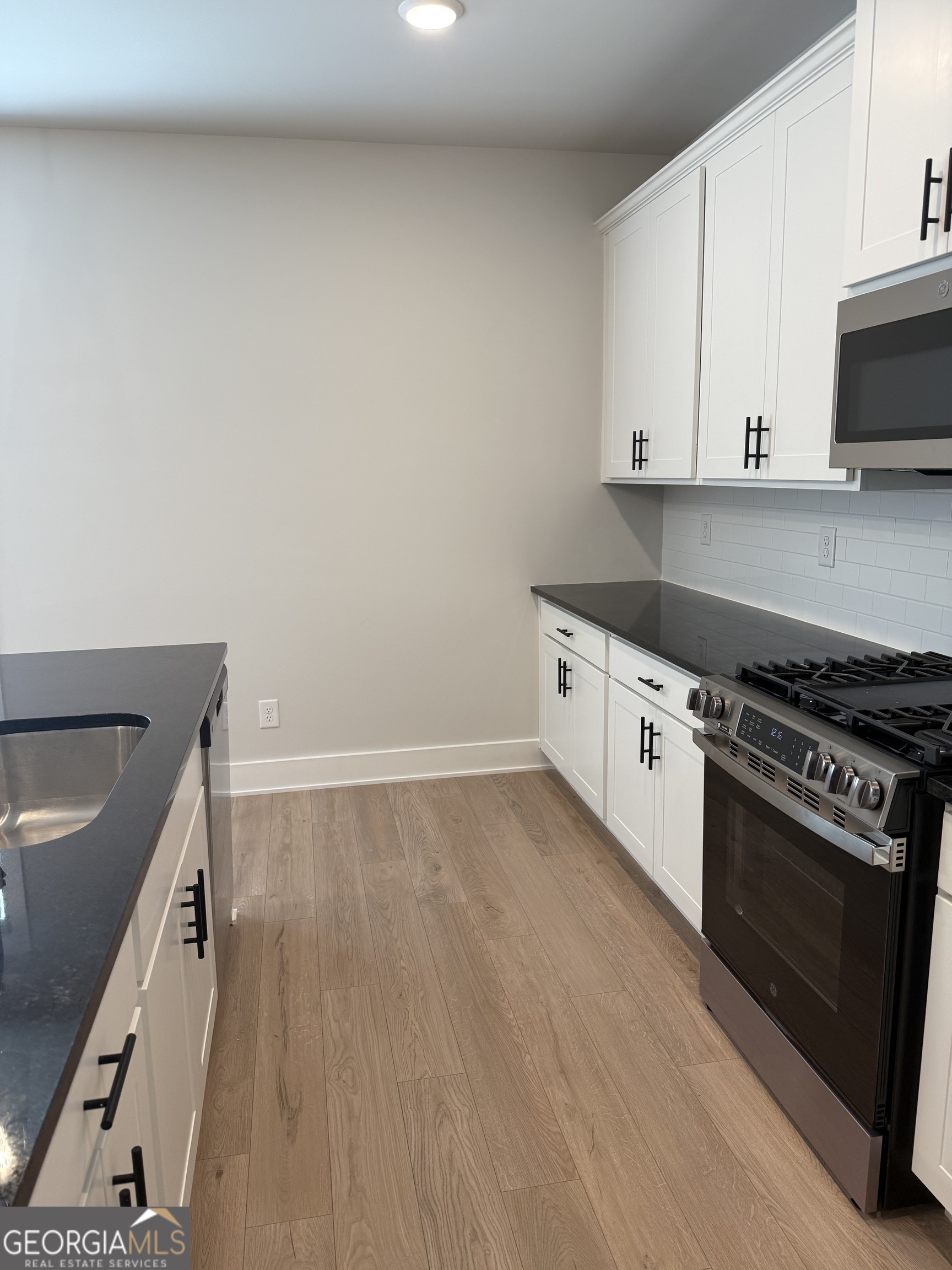 210 Villa Rica Springs Villa Rica, GA 30180 - Photo 6 of 24 a kitchen with granite countertop a stove and a sink
