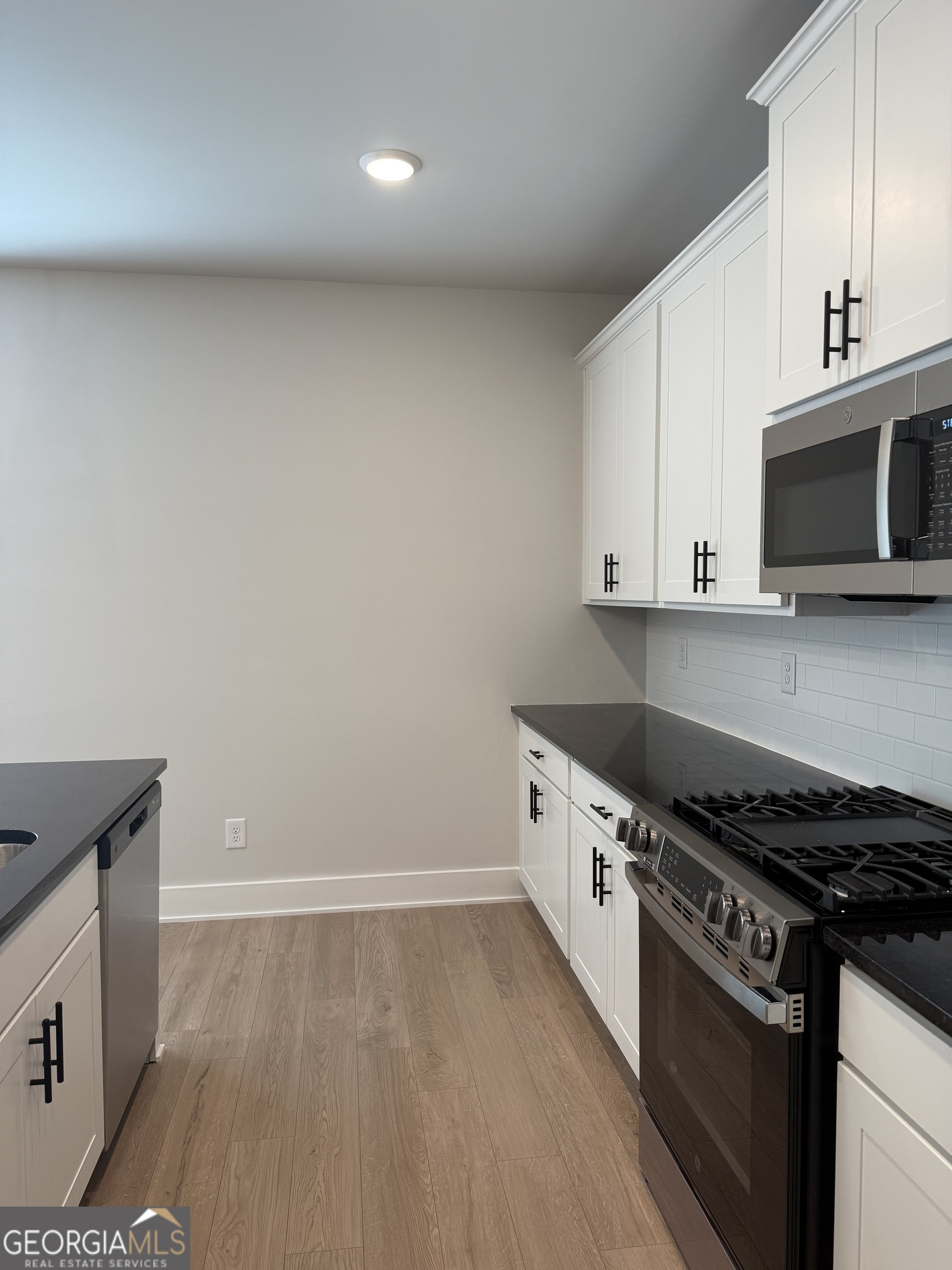 210 Villa Rica Springs Villa Rica, GA 30180 - Photo 7 of 24 a kitchen with granite countertop a stove and a microwave
