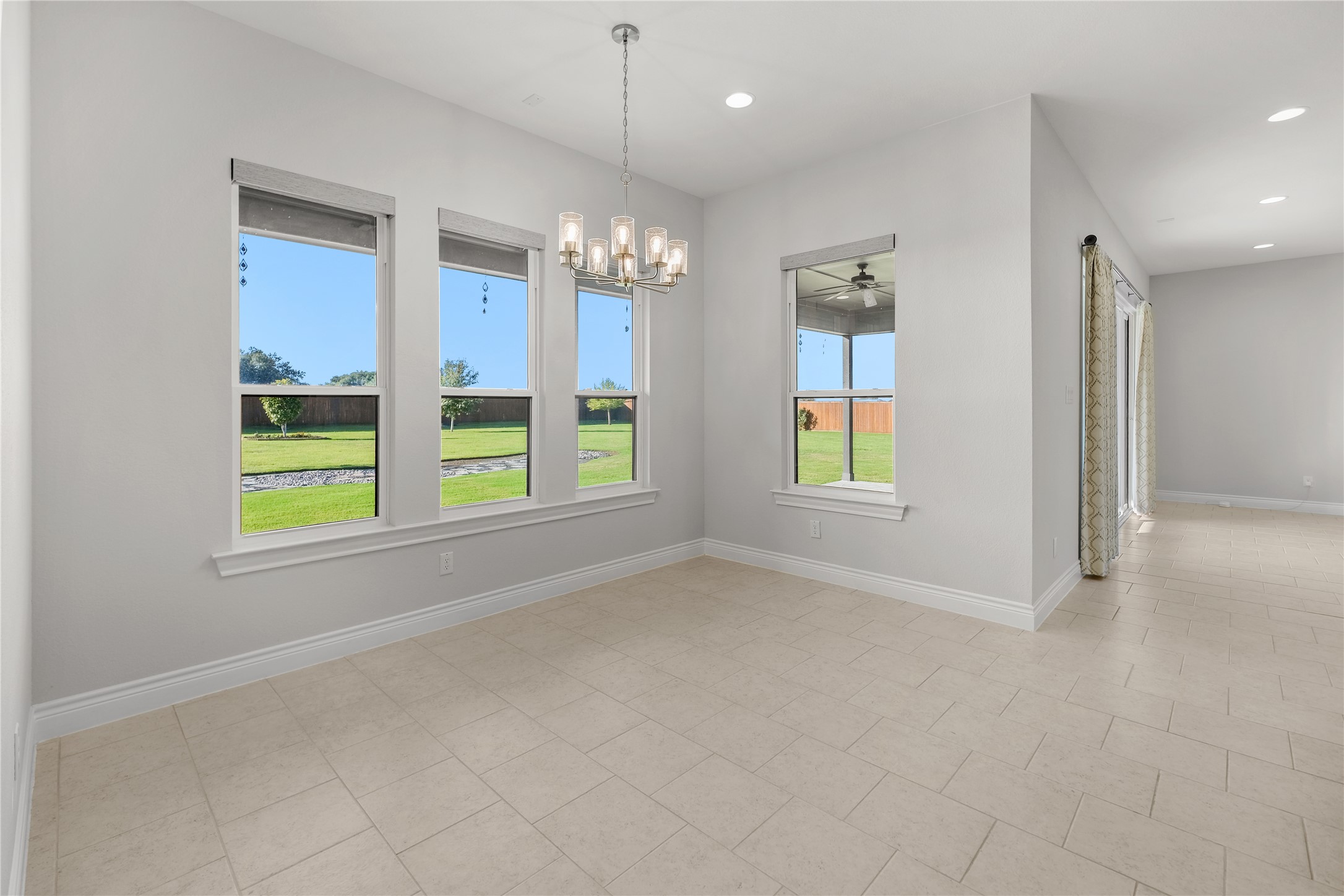 955 Inka Road Salado, TX 76571 - Photo 26 of 39 High ceilings and clean tile flooring define this airy dining area overlooking the yard.