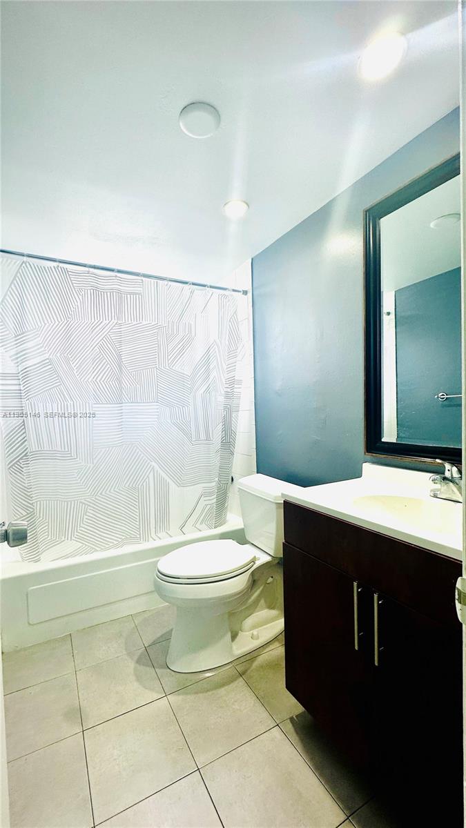 8101 Southwest 73rd Avenue, Unit 20 Miami, FL 33143 - Photo 13 of 18 a bathroom with a double vanity sink toilet and shower