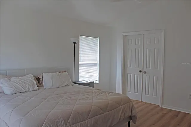 a bedroom with a bed and a window