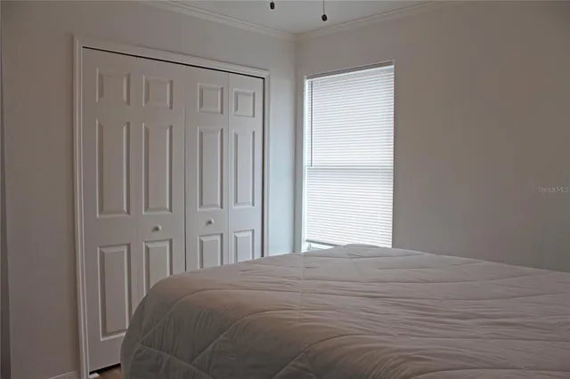 a bedroom with a bed and a window