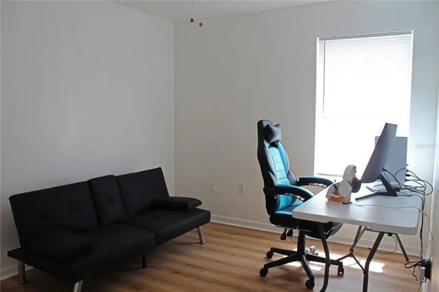 a living room with furniture a rug and a window