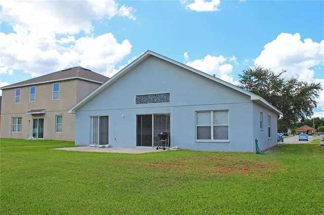 a view of a house with a backyard
