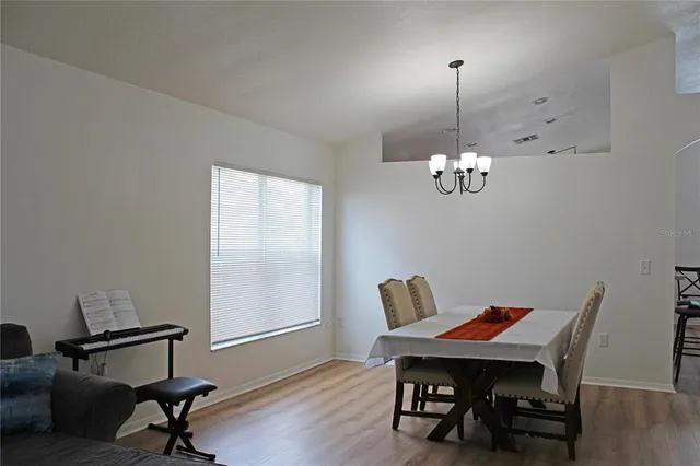 a view of a dining room with furniture wooden floor and chandelier