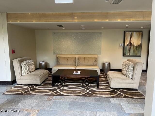 68 East Meadow Drive, Unit 726 Vail, CO 81657 - Photo 7 of 12 a living room with a couch and a potted plant on coffee table