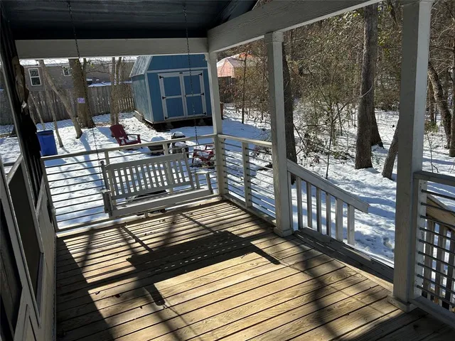a view of a white house with a large tree