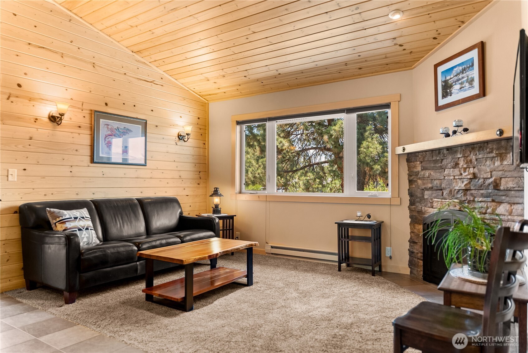 130 Sundown Road Winthrop, WA 98862 - Photo 37 of 40 a living room with furniture a fireplace and a flat screen tv