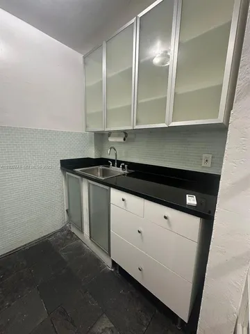 a kitchen with a sink and cabinets