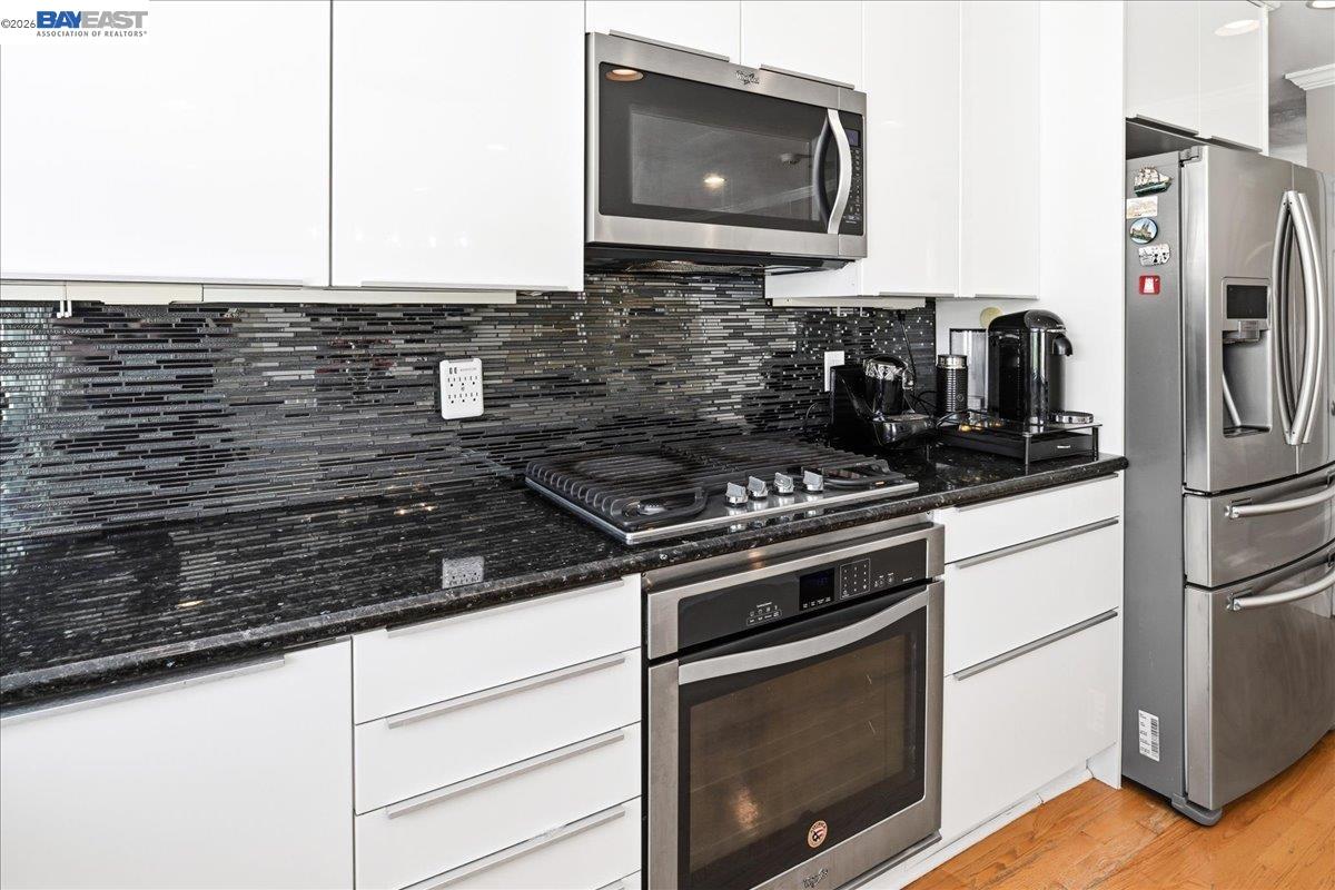 2861 Millbridge Place San Ramon, CA 94583 - Photo 16 of 58 a kitchen with stainless steel appliances a stove microwave and sink