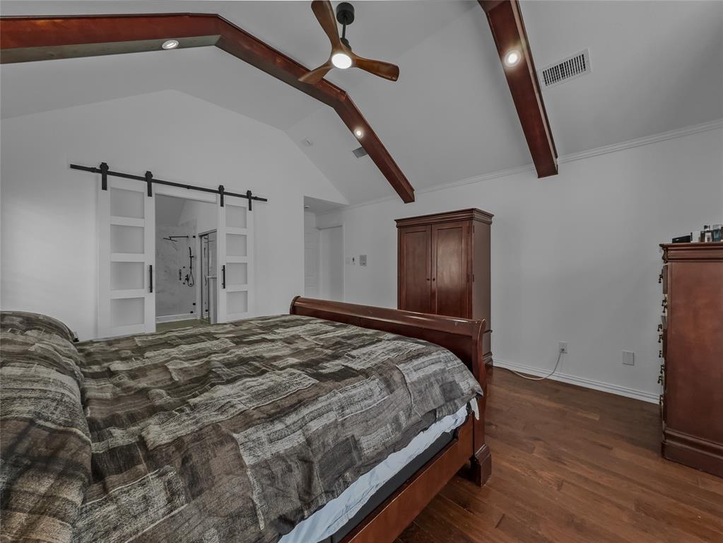 2317 Wellesly Road Rowlett, TX 75089 - Photo 17 of 39 a bedroom with a bed and wooden floor