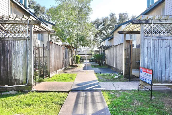 a view of yard with small huts and wooden fence