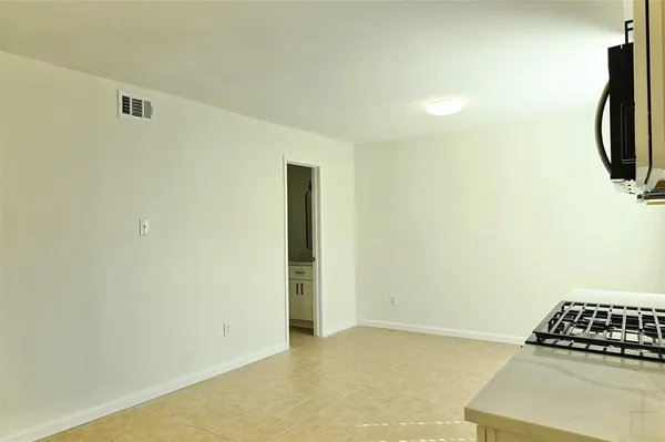 a kitchen with a stove a sink and a refrigerator