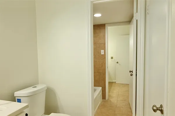 an empty room with a chandelier fan