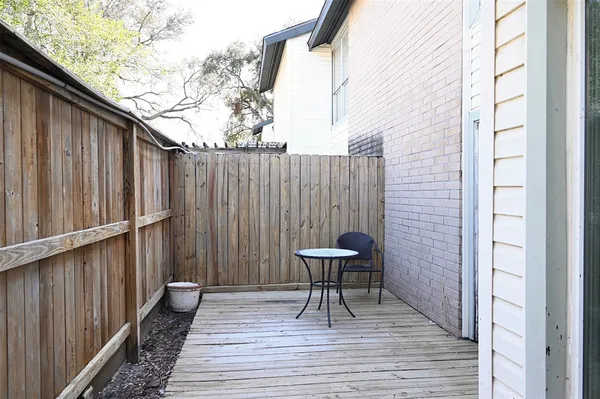 a view of a hallway with wooden floor and entryway