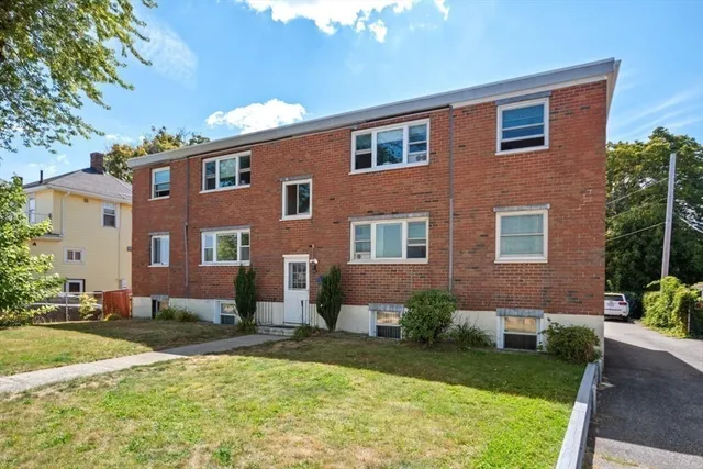 an aerial view of a house with yard