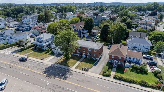 an aerial view of residential houses with outdoor space