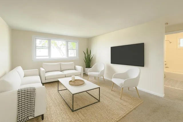 a bedroom with a large bed lamp and a window