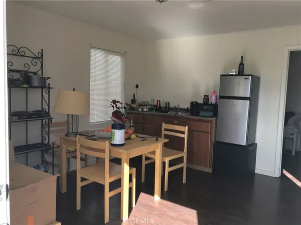 a kitchen with stainless steel appliances kitchen island granite countertop a refrigerator and a stove top oven