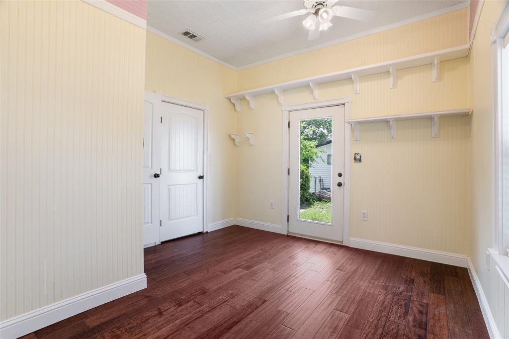 5824 Boone Street Sachse, TX 75048 - Photo 18 of 40 an empty room with wooden floor and a ceiling fan