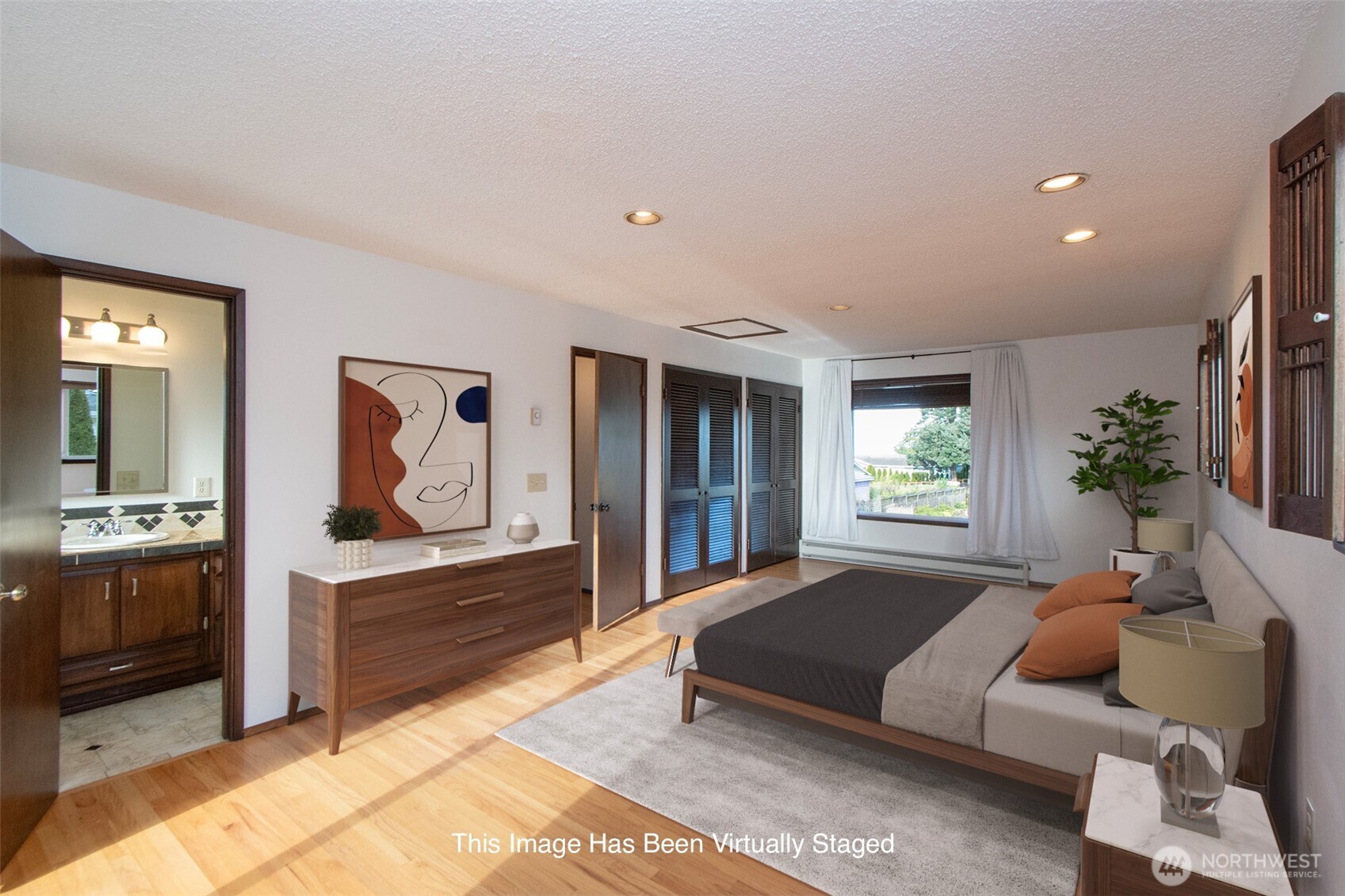 103 Island View Road Port Angeles, WA 98362 - Photo 18 of 40 a spacious bedroom with a bed and a couch