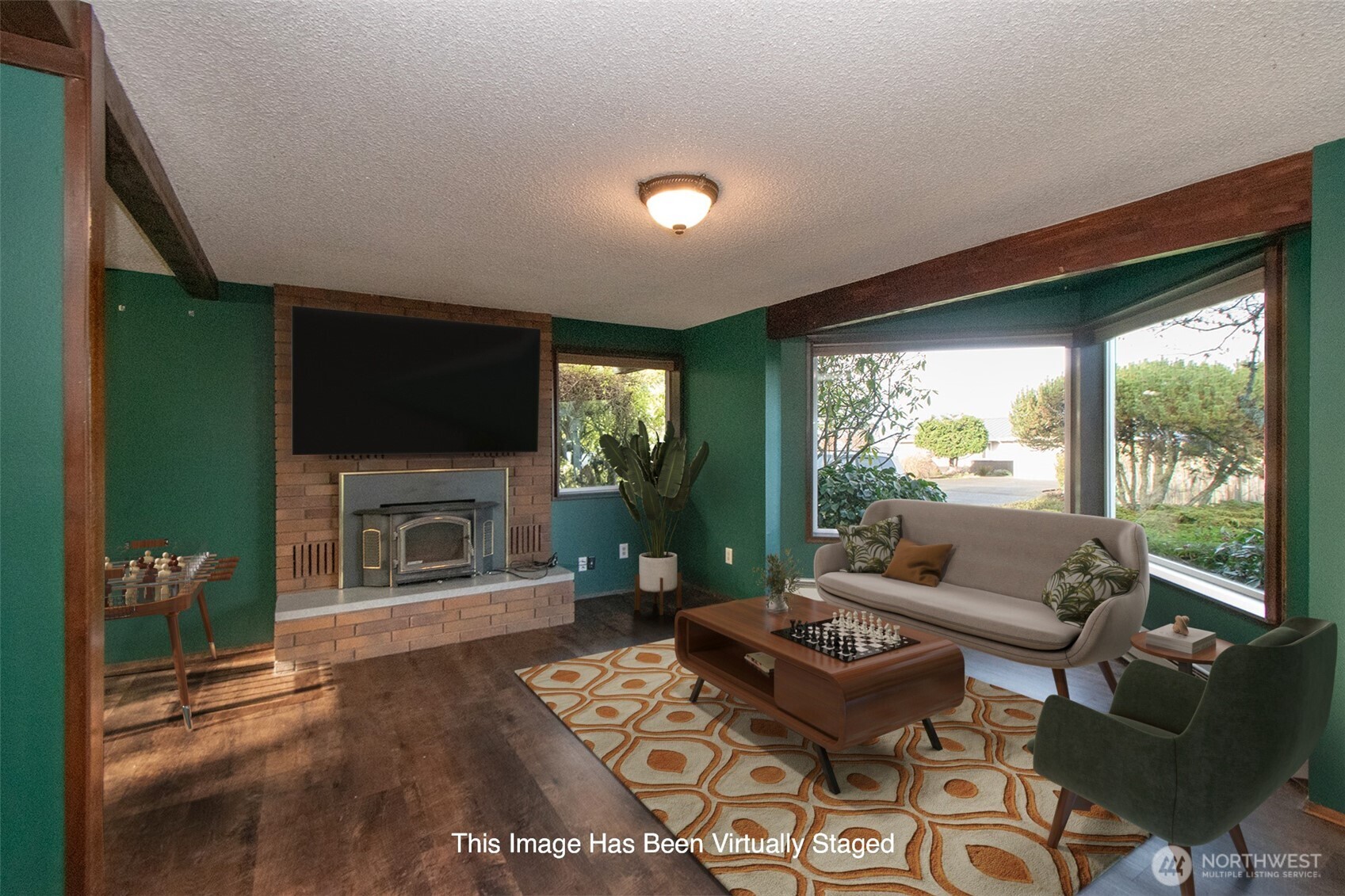 103 Island View Road Port Angeles, WA 98362 - Photo 21 of 40 a living room with furniture a flat screen tv and a fireplace