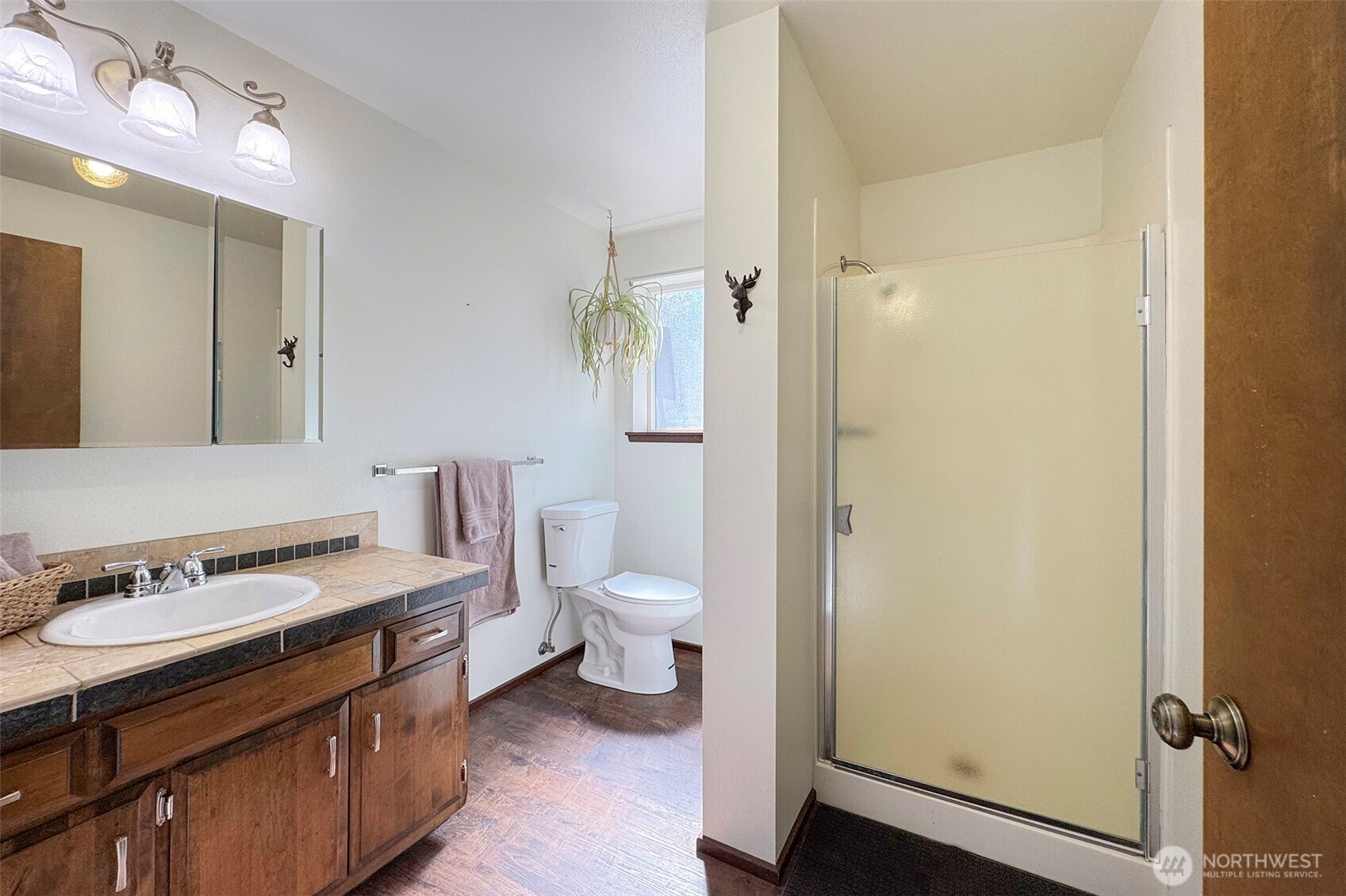 103 Island View Road Port Angeles, WA 98362 - Photo 24 of 40 a bathroom with a granite countertop sink toilet a mirror and shower