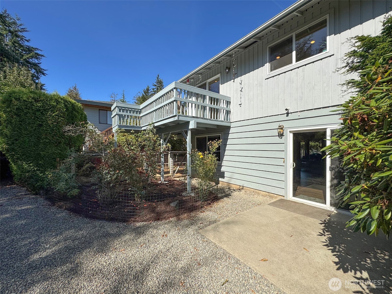 103 Island View Road Port Angeles, WA 98362 - Photo 29 of 40 a view of a white house with a large windows yard and plants