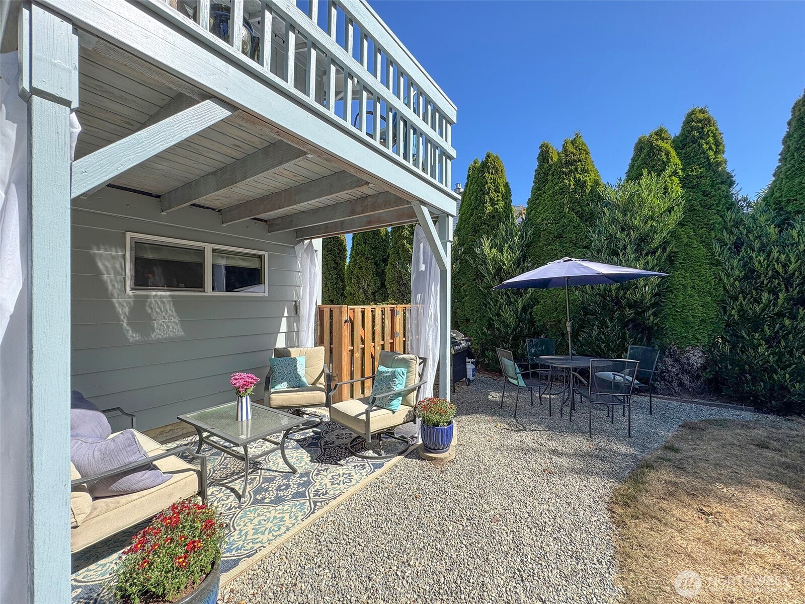 103 Island View Road Port Angeles, WA 98362 - Photo 32 of 40 a backyard of a house with table and chairs