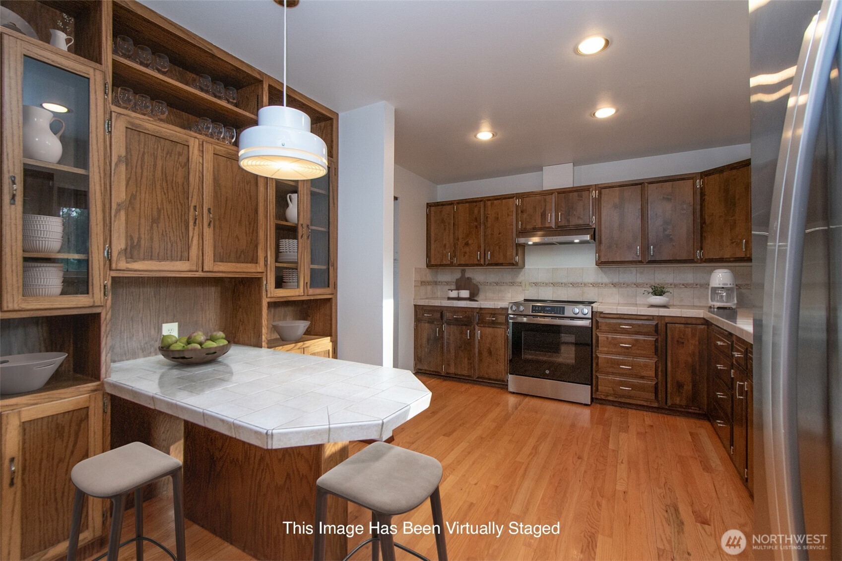 103 Island View Road Port Angeles, WA 98362 - Photo 8 of 40 a kitchen with stainless steel appliances granite countertop a stove a sink dishwasher a microwave oven and a dining table with wooden cabinet