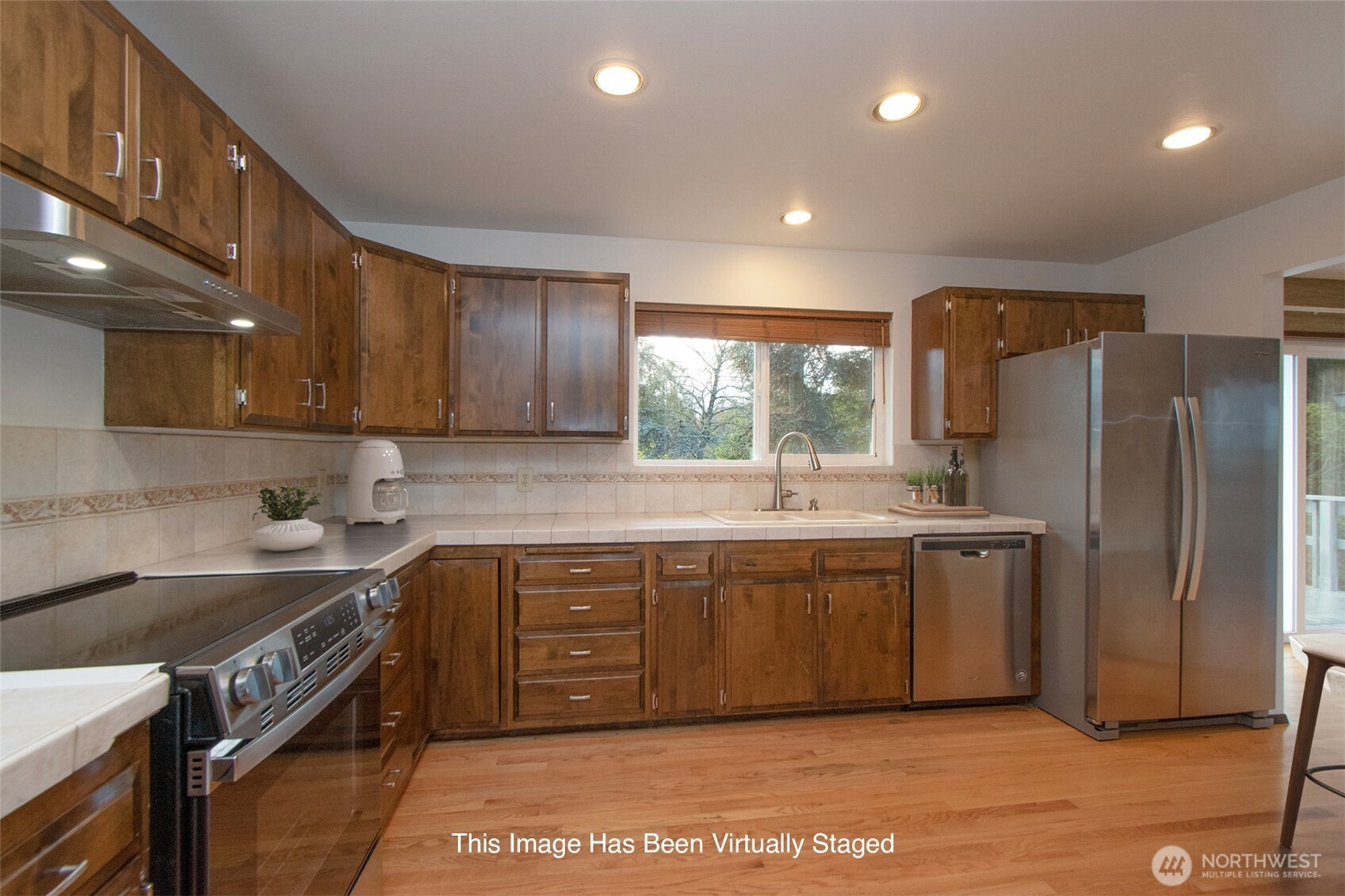 103 Island View Road Port Angeles, WA 98362 - Photo 9 of 40 a kitchen with stainless steel appliances granite countertop a sink a stove a refrigerator and island