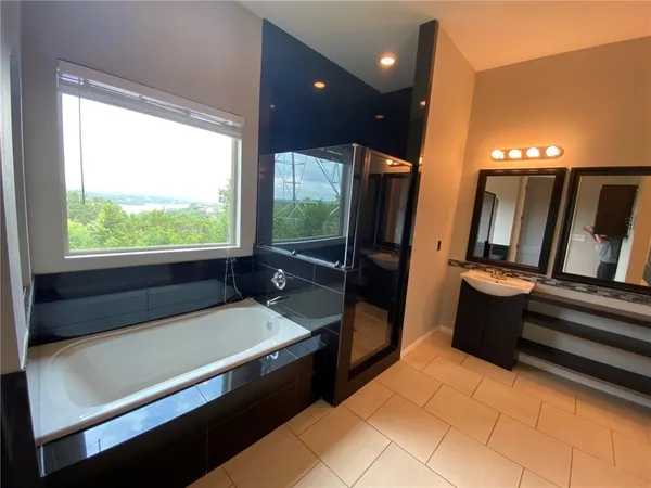 a bathroom with a bathtub and a double vanity sink