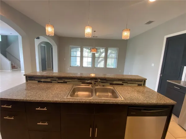 a kitchen with a sink a counter space and a window