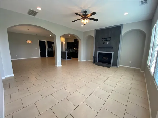 an empty room with windows and cabinet