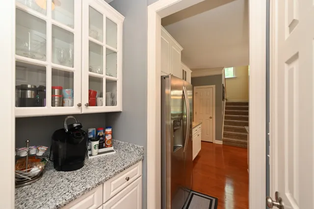 a view of a hallway with wooden floor and stairs