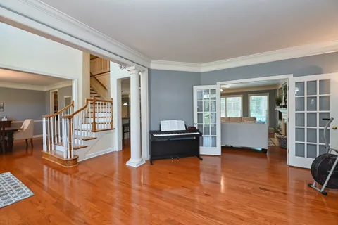 a living room with furniture and a wooden floor