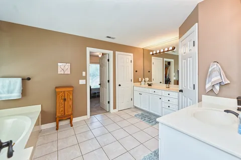 a bathroom with a sink a toilet and mirror
