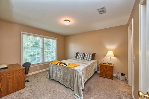 a bedroom with a bed and a window