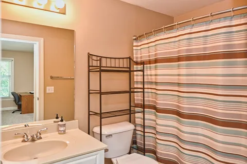 a bathroom with a sink toilet and shower