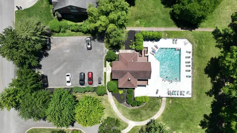 an aerial view of a house with outdoor space pool seating area and yard