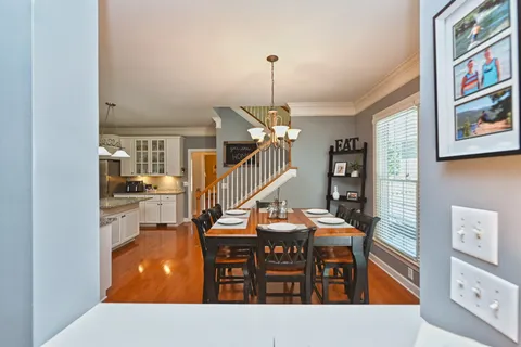 a living room with furniture a piano and a bookshelf