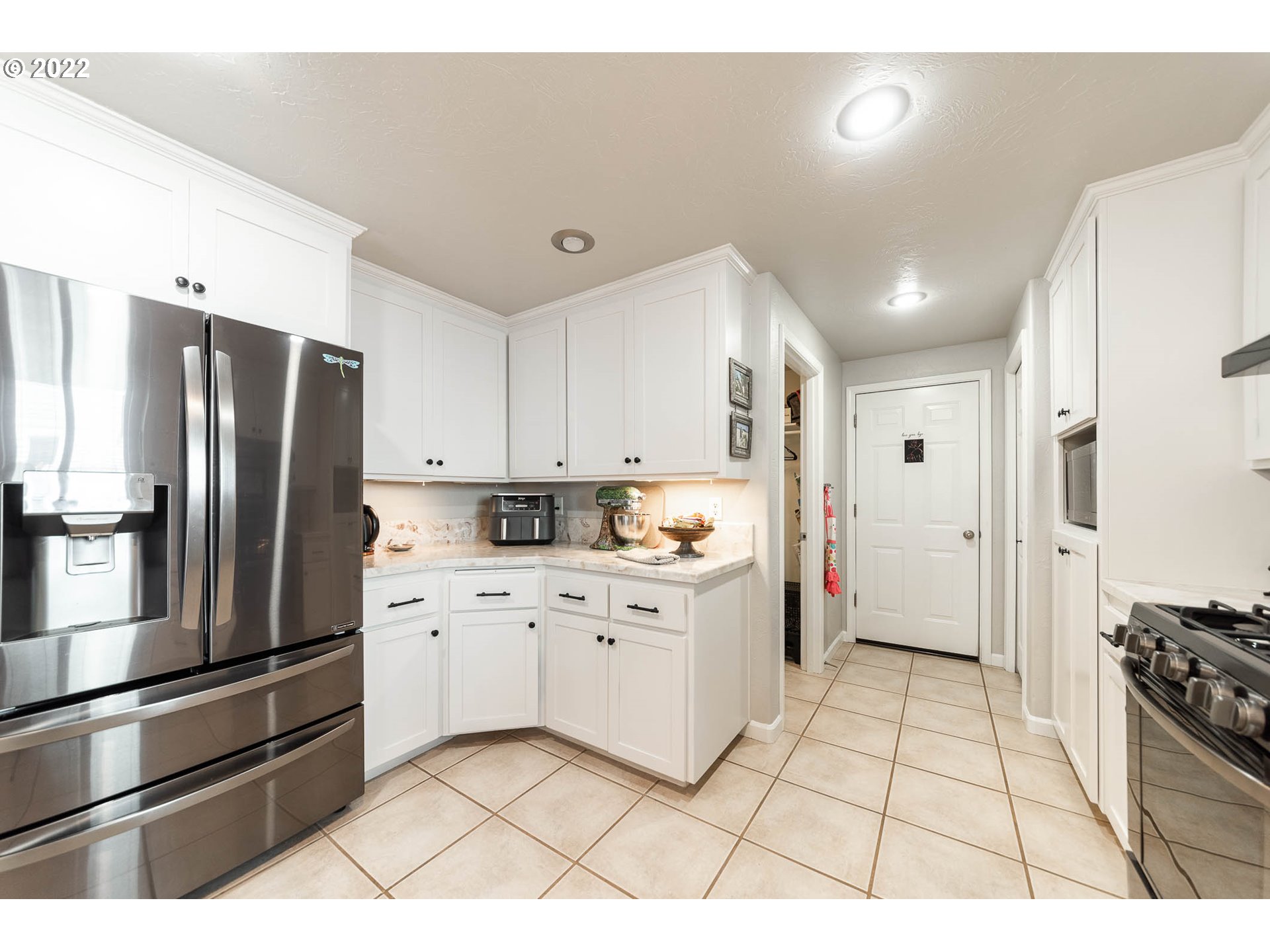 659 62nd Street Springfield, OR 97478 - Photo 18 of 32 a kitchen with stainless steel appliances a refrigerator sink and cabinets