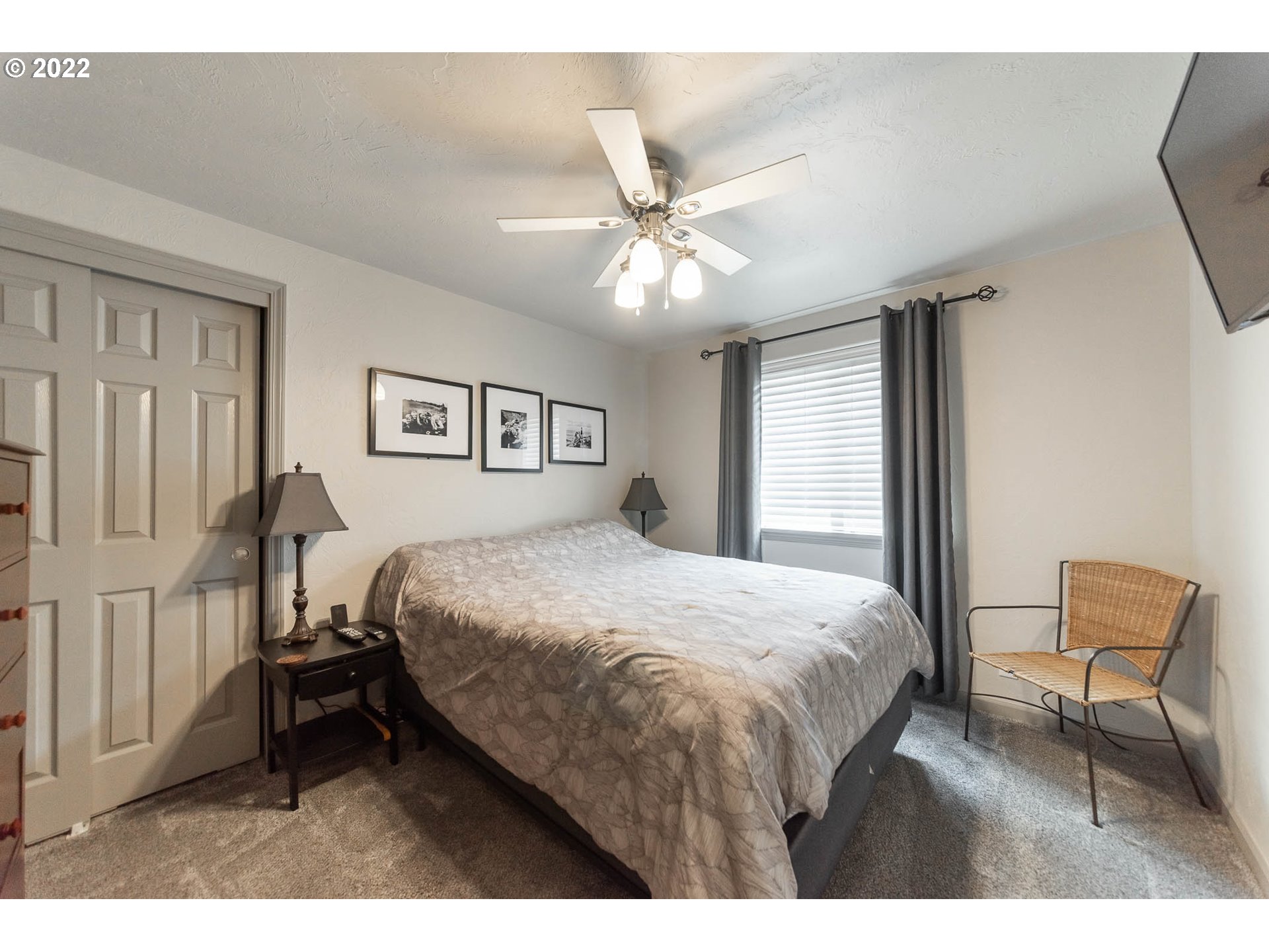 659 62nd Street Springfield, OR 97478 - Photo 6 of 32 a bedroom with a bed a chair and a large window