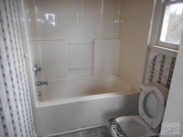 453 Poors Ford Road Rutherfordton, NC 28139 - Photo 13 of 15 a white toilet sitting next to a bath tub